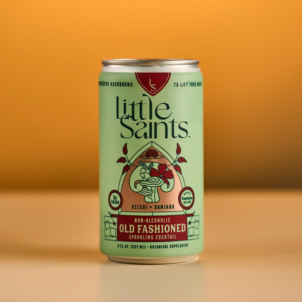 Little Saints Old Fashioned alcohol-free sparkling cocktail can on an orange background
