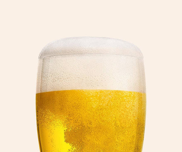 Close-up glass of Best Day Brewing Electro-Lime non-alcoholic beer with foamy head