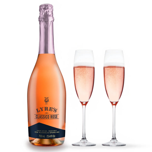 Bottle of Lyre's Classico Rosé non-alcoholic sparkling wine beside two filled champagne flutes.