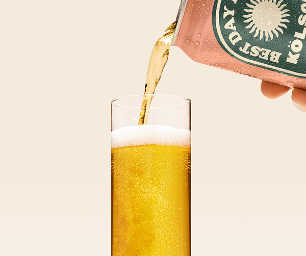 Best Day Kölsch non-alcoholic beer poured from can into a tall glass with a foamy head