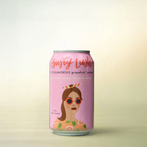 Busty Lush She's Glamorous Grapefruit Paloma, alcohol-free cocktail, can on a soft gradient background