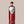 Bottle of Ghia non-alcoholic aperitif featuring a ribbed red glass design, light blue label, and round wooden cap, displayed against a white background.