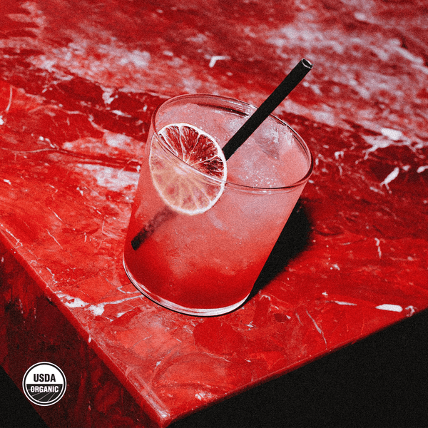 hiyo Blackberry Lemon alcohol-free functional seltzer served in a glass with dried lime wheel and straw
