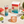 hiyo Watermelon Lime alcohol-free seltzer can, four-pack box, and glass over ice with fresh watermelon and lime