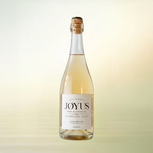 Joyus non-alcoholic sparkling wine, 750 ml bottle on cream background