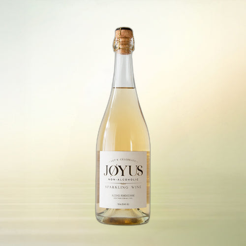 Joyus non-alcoholic sparkling wine, 750 ml bottle on cream background