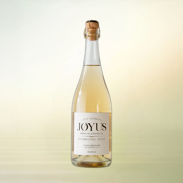Joyus non-alcoholic sparkling wine, 750 ml bottle on cream background