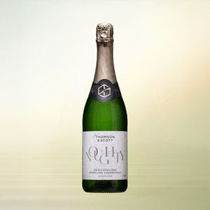 Noughty Sparkling Chardonnay non-alcoholic wine bottle on cream background