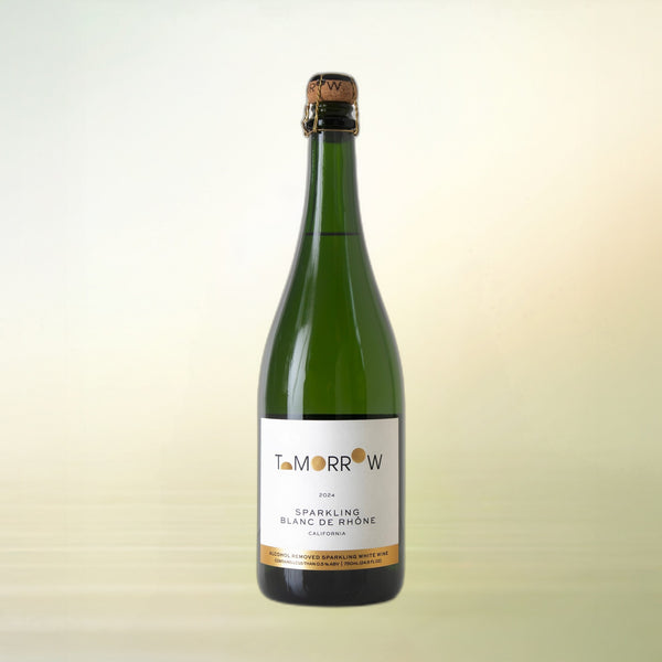 Tomorrow Cellars Sparkling Blanc de Rhône non-alcoholic wine bottle on cream background